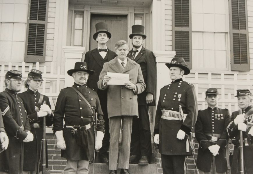 Wayne C. Temple stands attired as a general in the Illinois militia and an officer of the 114th Illinois Volunteer Infantry, as Gov. Daniel Walker reads a proclamation dedicating Lincoln’s Post Road to New Salem on January 23, 1976. Behind the governor stand two Lincoln presenters, one with a beard and one without. 