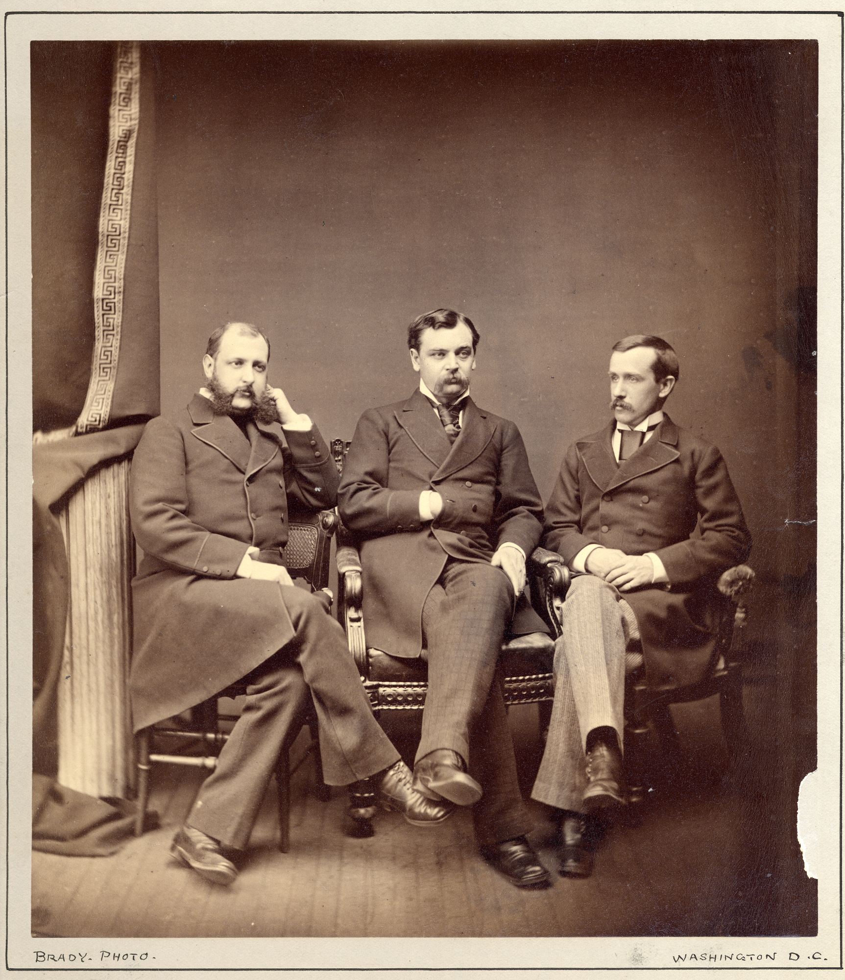 Photograph of Robert Todd Lincoln seated between Edgar T. Welles (left) and Edwin L. Stanton (right)