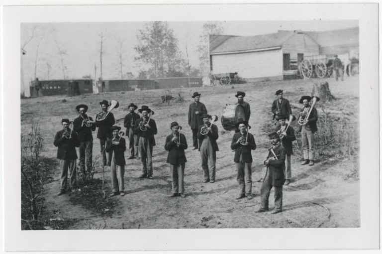 Civil War band, standing, in uniform, holding instruments
